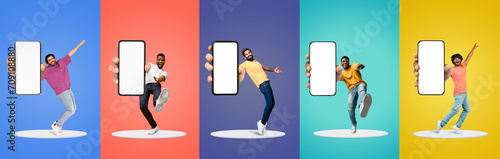 Diverse Happy Males Dancing With Big Blank Smartphone In Hands