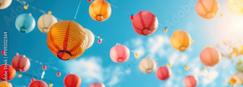 colorful paper lanterns hanging above a blue sky