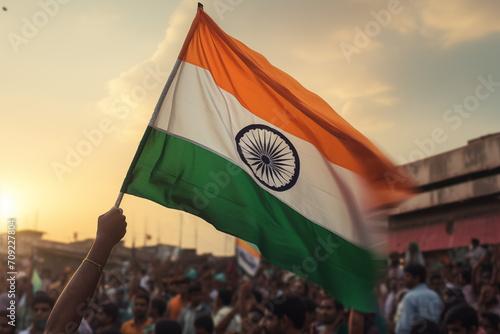 Man holding the flag of India in front of a crowd of The country of India. The symbol of India. Country South Asia, capital New Delhi. Country South Asia, capital New Delhi. Official language Hindi. ​