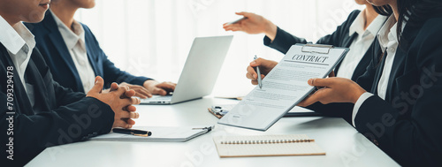 Two business executive in boardroom discuss term and company merging agreement, review corporate contract document as business partnership and cooperation with acquisition and merger concept. Shrewd