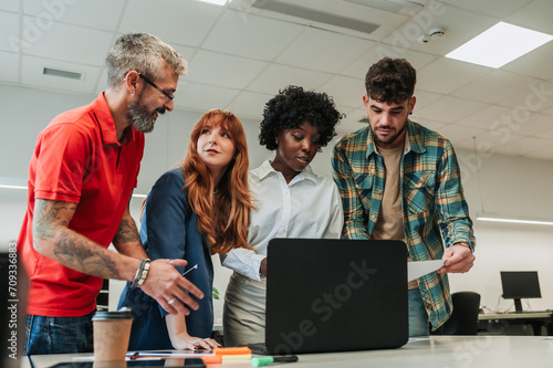 An interracial group of experts having meeting at the office.