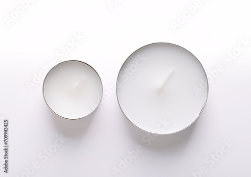 Common tealight and a maxi tealight, from above. Two types of tea lights, also called tea candle or t-lite, with different burning time, and a thin metal cup, so wax can liquefy completely while lit.