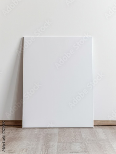 blank art canvas mockup on the laminate floor against the white wall