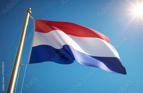Netherlands flag on the blue sky