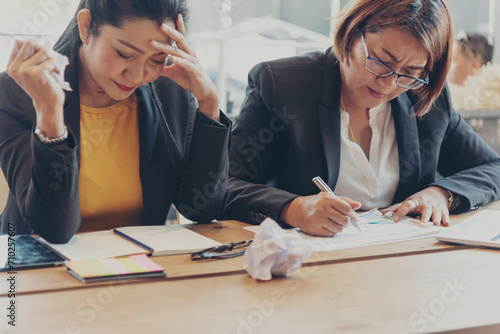 Asian businesswoman overworked at office stressful anxiety with serious problems. Woman exhaustion depress and mental burnout feeling tired frustrate at company office. Stress sadness contemplation