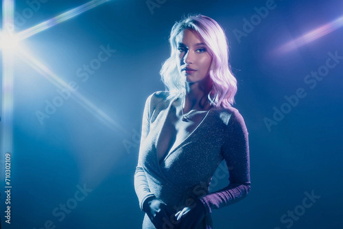 Stunning Blonde Woman with Mesmerizing Blue Eyes Strikes a Pose in Studio with Creative Spotlight Effects - A Visual Delight!