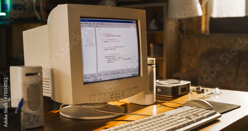 Close Up Shot Of Old Desktop Computer On Work Desk Of Software Engineer In Retro Garage. Dated PC Has Operating System Terminal Opened, Prompts Running On Screen, Code Functioning Successfully.