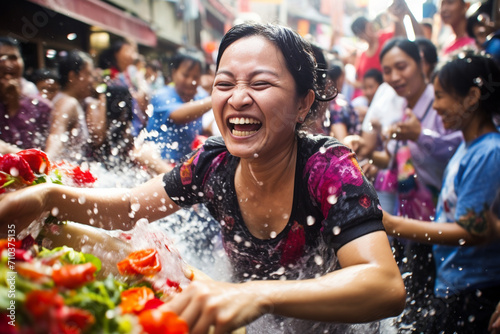 thai woman playing water in songkran festival bokeh style background