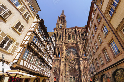 Street view on the beautiful old buildings - Notre-Dame cathedral in Strasbourg city. Alsace, France