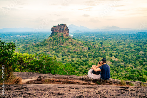 Couple in Sigiriya, rock view. Woman and man, summer travel. People on vacation in Sri Lanka. Beautiful nature with green landscape and mountains. Romance on Pidurangala. Honeymoon tourism.