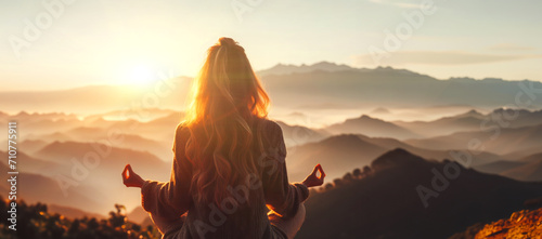 Banner Woman practicing yoga and meditation on mountain at sunset