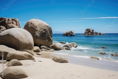 A picturesque sandy beach with magnificent large rocks jutting out of the crystal-clear water, Big rocks on the ocean landscape beach view with a blue sky, AI Generated