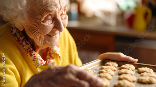Happy elderly woman baking cookies at home. Senior people doing hobby and activity.