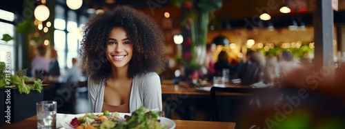 African American woman eating healthy food in a restaurant