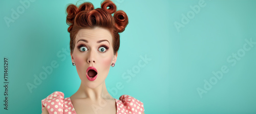 Woman with red lips surprise.Beautiful girl with curly hair surprised and shocked looks on you . Presenting your product. Portrait of impressed pretty person open mouth look camera news information 