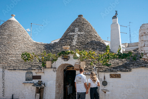 Tourist couple in the beautiful village of Alberobello in Italy