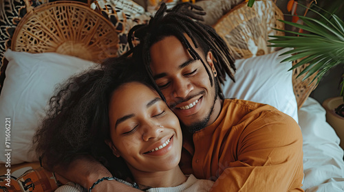 Young multiethnic couple hugging lying bed at home cuddling