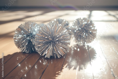 Silver Cheerleading Pompoms On Wooden Gym Floor