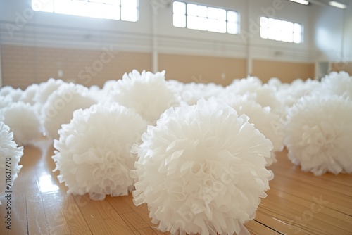 White Cheerleading Pompoms On Wooden Gym Floor