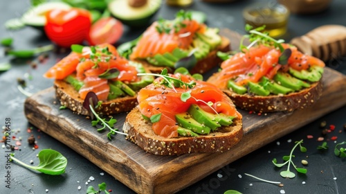 Open sandwiches with salted salmon, guacamole avocado and microgreens. Healthy food