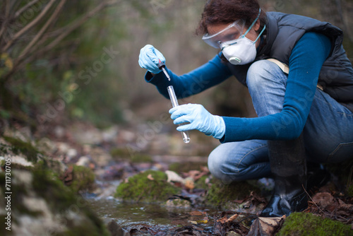 Determinate Biologist Adult Woman On Field Test of Water Stream to Reagents