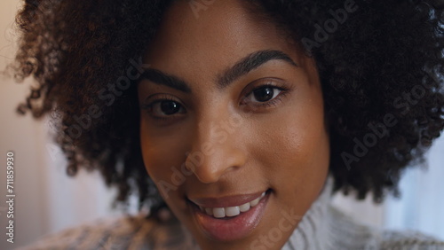 Portrait curly model laughing indoors. Brown eyes girl having fun looking camera