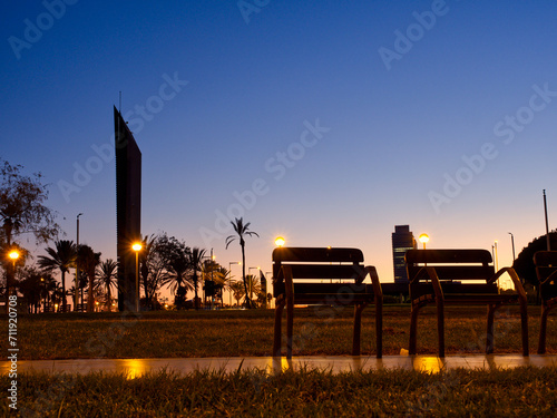 Low angle view of chairs in seaside promenade la barceloneta during blue hour. Barcelona, Spain 