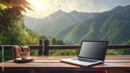 Workspace with laptop and coffee on wooden table with beautiful nature background. - digital nomad concept.