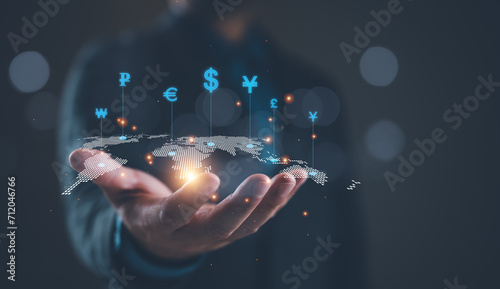 Global currency exchange concept, Businessman holding virtual world map and dollar yuan yen euro and pound sterling sign. Global business, international trading currency, world economy money, transfer