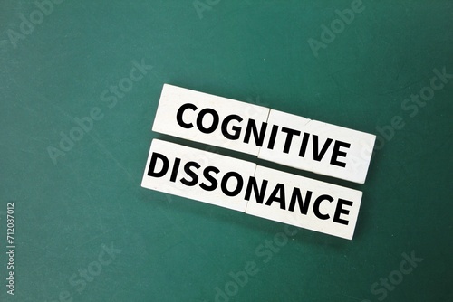 white wood with the word cognitive dissonance. the state of having inconsistent thoughts