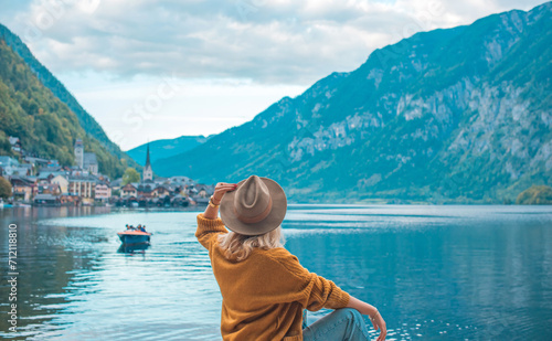 Vacation in Austria. Concept of tourism and holidays. Woman resting in Hallstatt, nature scene