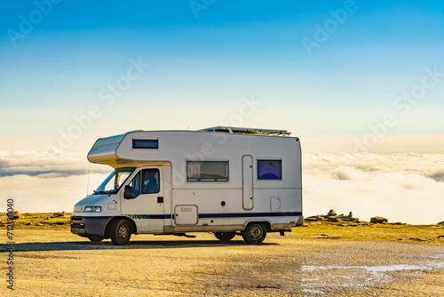 Rv caravan in mountains above clouds
