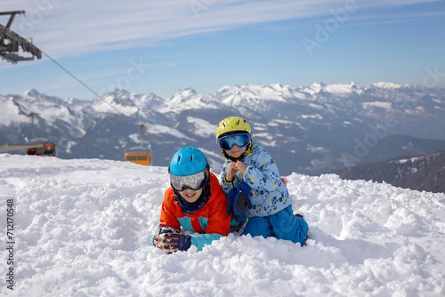 Happy family, enjoying ski holiday with children, sunny beautiful weather