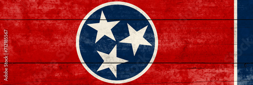 Tennessee State flag on a wooden surface. Banner of the grunge Tennessee State flag.