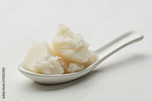 Solidified lard on white background in a spoonful