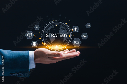 business strategy and Action plan. Businessman holding virtual globe with strategy icons for Strategic planning for business success. business development concept.
