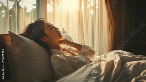 Simple lifestyle, Asian woman wakes up from good sleep on weekend morning, takes some rest, relax in comfortable bedroom at hotel window, happy lazy day, comfortable, dreaming