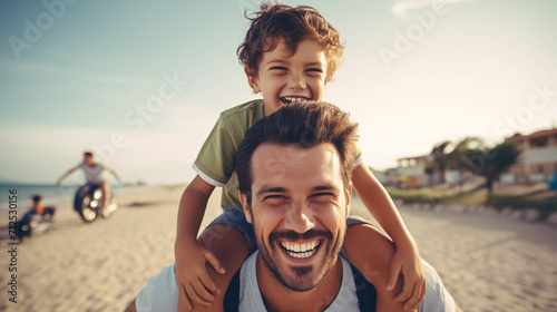 Caucasian boy riding on the back of his father at the beach.