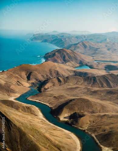 an aerial view of a lake and some mountains by the ocean