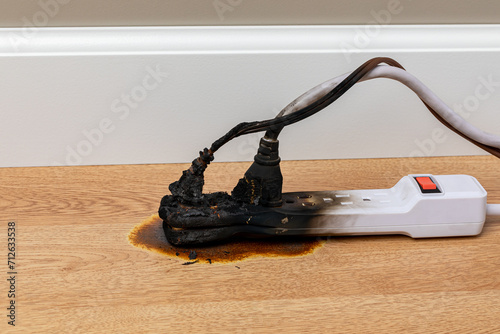 Electrical surge protector outlet and extension cord fire. Electricity safety, fire hazard and circuit overload concept.