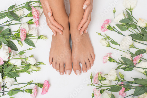 Beautiful female feet with flowers in the background.