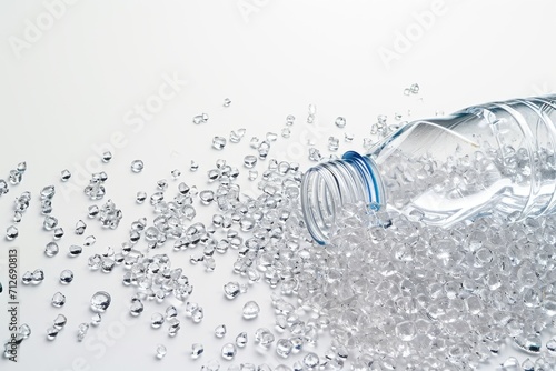 Transparent plastic bottle and PVC granulate background, recycled plastic granules, biodegradable plastic. Granules of eco-friendly plastic raw material.