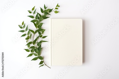 Old retro book with green leafs on white background