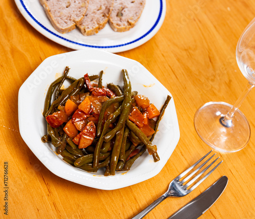 Close-up of hearty Spanish dish with green beans, carrots and chorizo