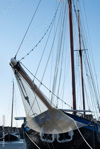 Ship's bow with jib boom and tightly knotted jib net in front of the foremast of a moored sailing ship, stretched between the two bow stays. You can stand here to raise the jib