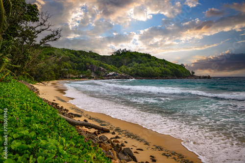 Tropical beach at Mahe Island, Seychelles, during sunset. Mahe Island is the largest island in the Seychelles, known for its stunning beaches, verdant mountains, and vibrant Creole culture.