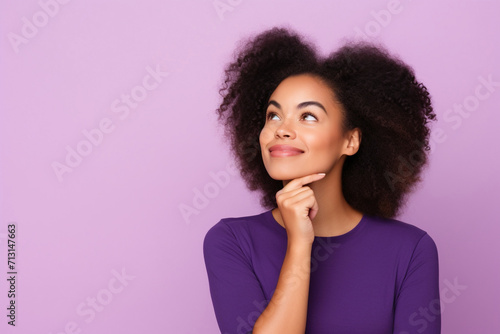 Cute African American lady thinking about her inspiration touch chin looking mockup choosing product option isolated on purple color background