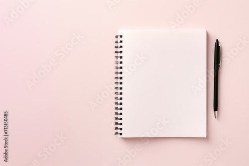 school notebook on a pink background, spiral notepad on a table