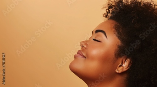 A joyful plus-size woman exudes positivity in her studio portrait.