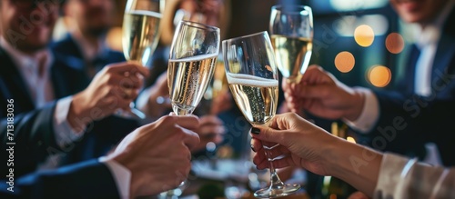 Group of intercultural business people in formalwear looking at man with flute of champagne pronouncing toast for successful project. Copy space image. Place for adding text